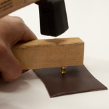 Setting a button stud with a piece of wood